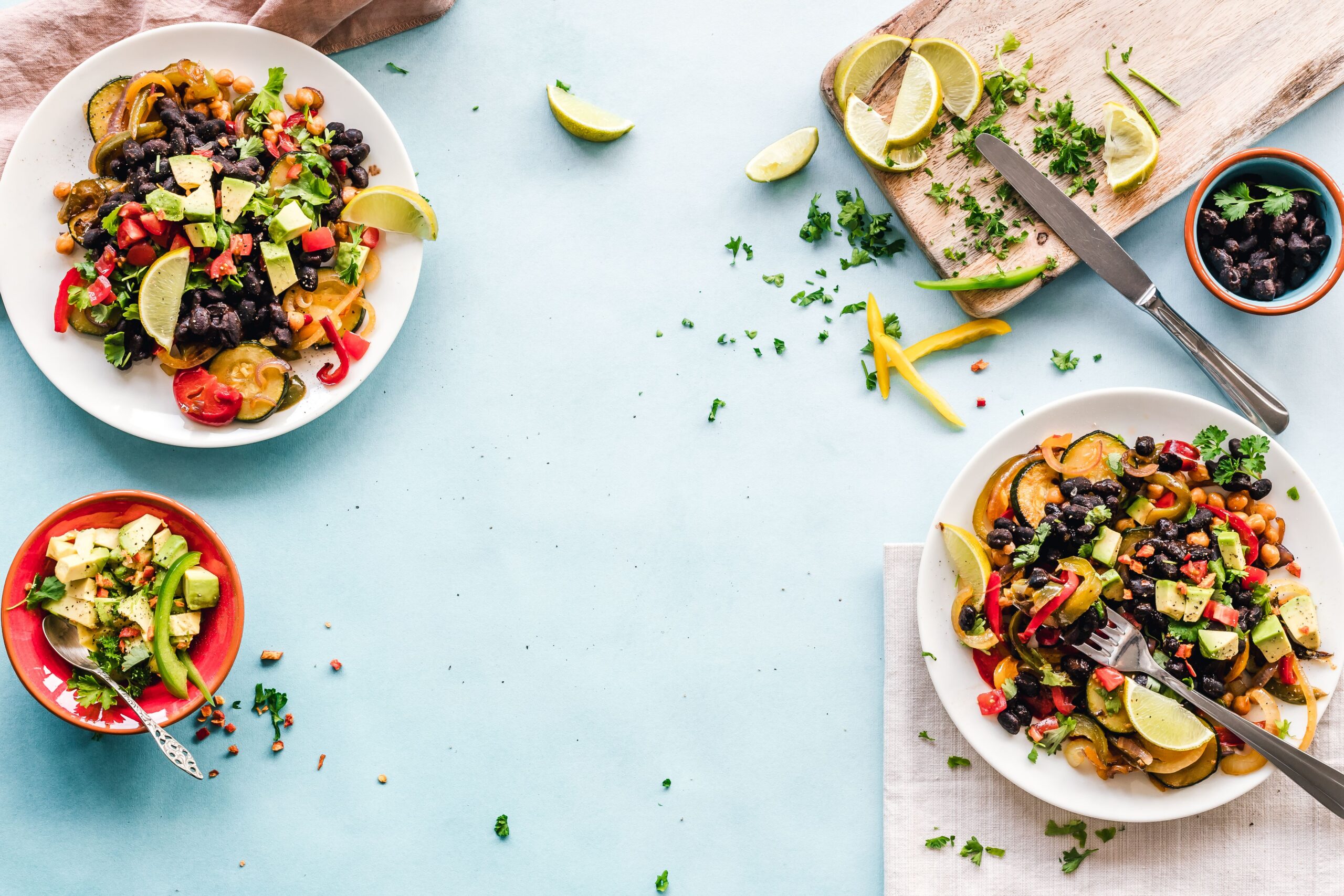 Colorful vegetable and bean meals with avocado and fresh lime